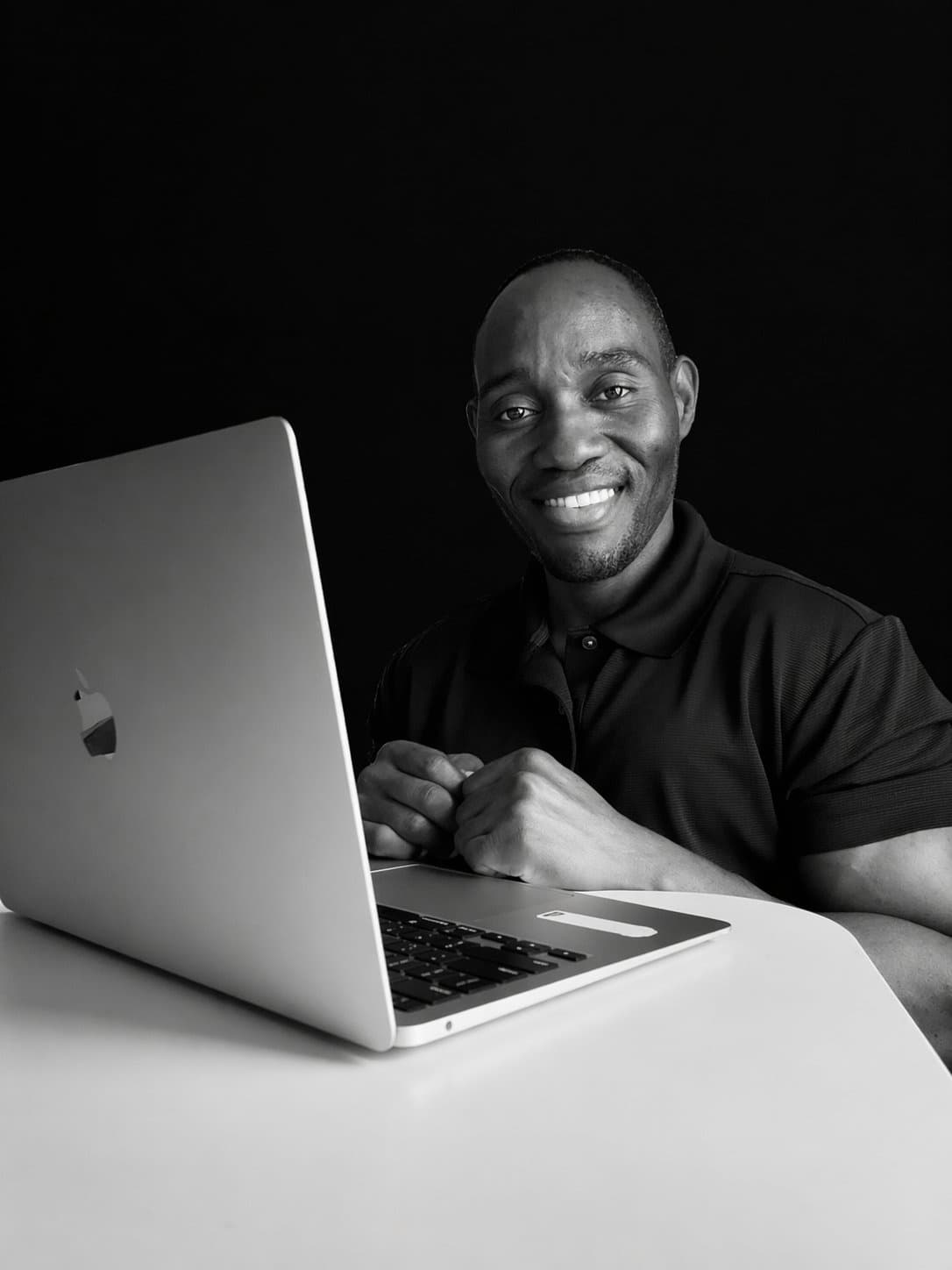 Coach reviewing client data at laptop